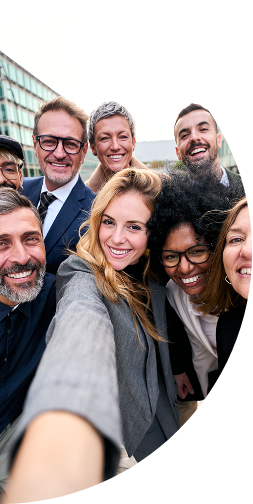 Happy team of professionals posing for a selfie photo during a workplace gathering.